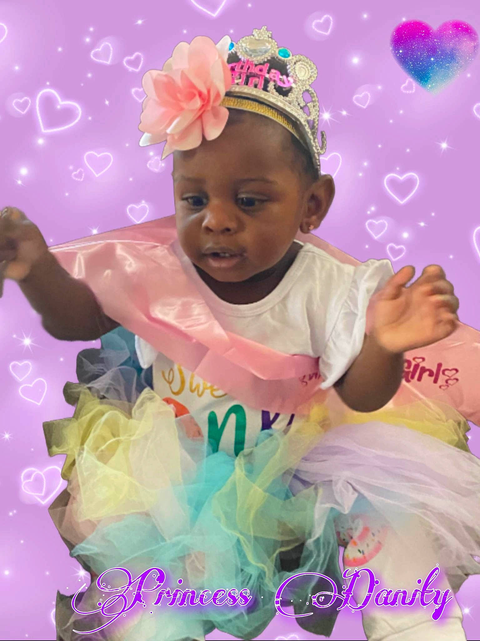 Danity is registered to the contest to win money with this photo: arm, baby, baby_toddler_clothing, birthday, child, event, facial_expression, fun, gesture, happy, headband, headpiece, human, magenta, party, party_supply, person, pink, product, toddler