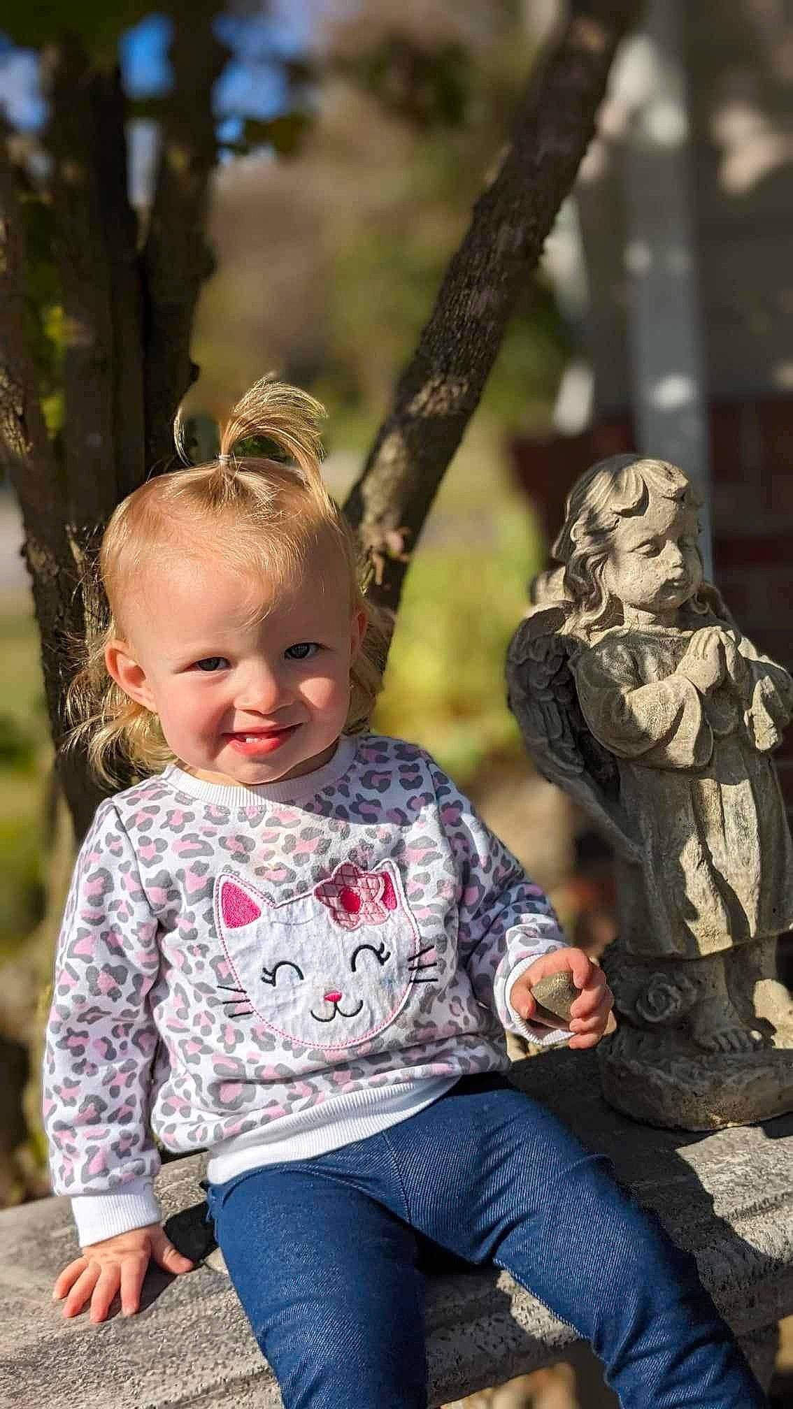 Oakley is registered to the contest to win money with this photo: baby_toddler_clothing, child, clothing, eye, facial_expression, fun, grass, happy, head, interaction, jeans, joy, leaf, leisure, people_in_nature, person, recreation, smile, standing, toddler