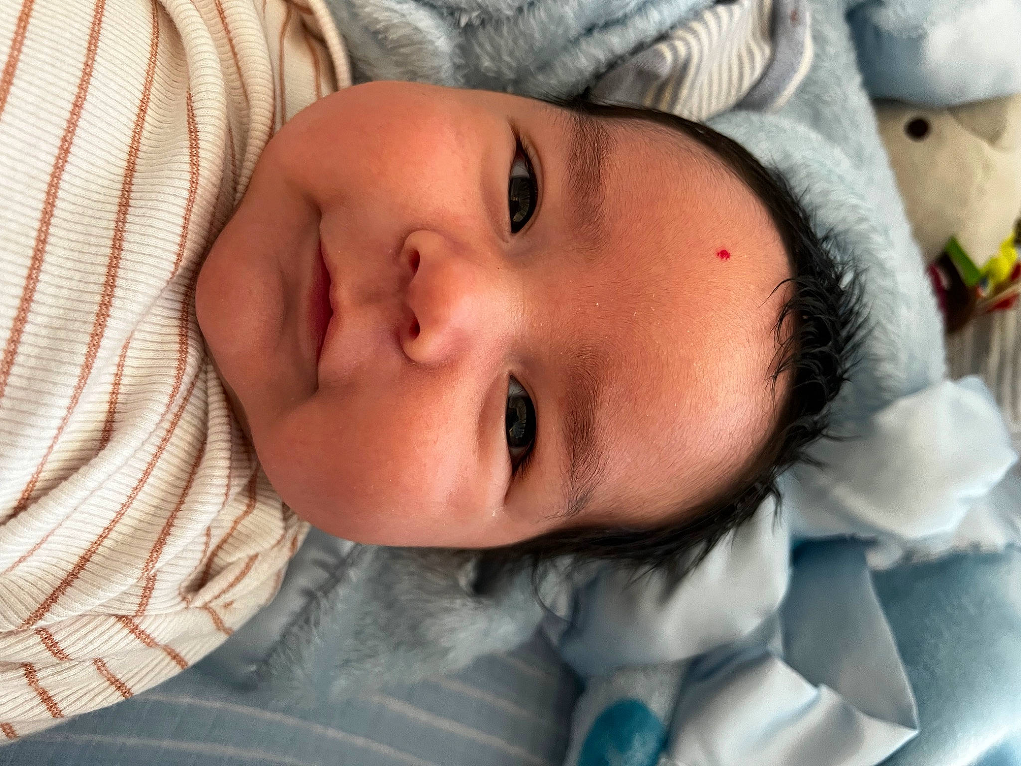 Logan is registered to the contest to win money with this photo: baby, baby_toddler_clothing, cheek, child, chin, comfort, eye, eyebrow, eyelash, face, forehead, head, headgear, iris, lip, mouth, nose, person, skin, smile