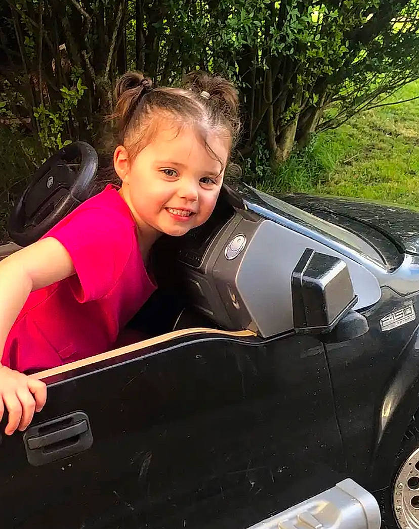 Jaylyn is registered to the contest to win money with this photo: auto_part, automotive_design, automotive_exterior, automotive_lighting, automotive_tire, automotive_wheel_system, bumper, fender, hood, joy, motor_vehicle, person, personal_luxury_car, plant, smile, tire, toddler, travel, tree, vehicle