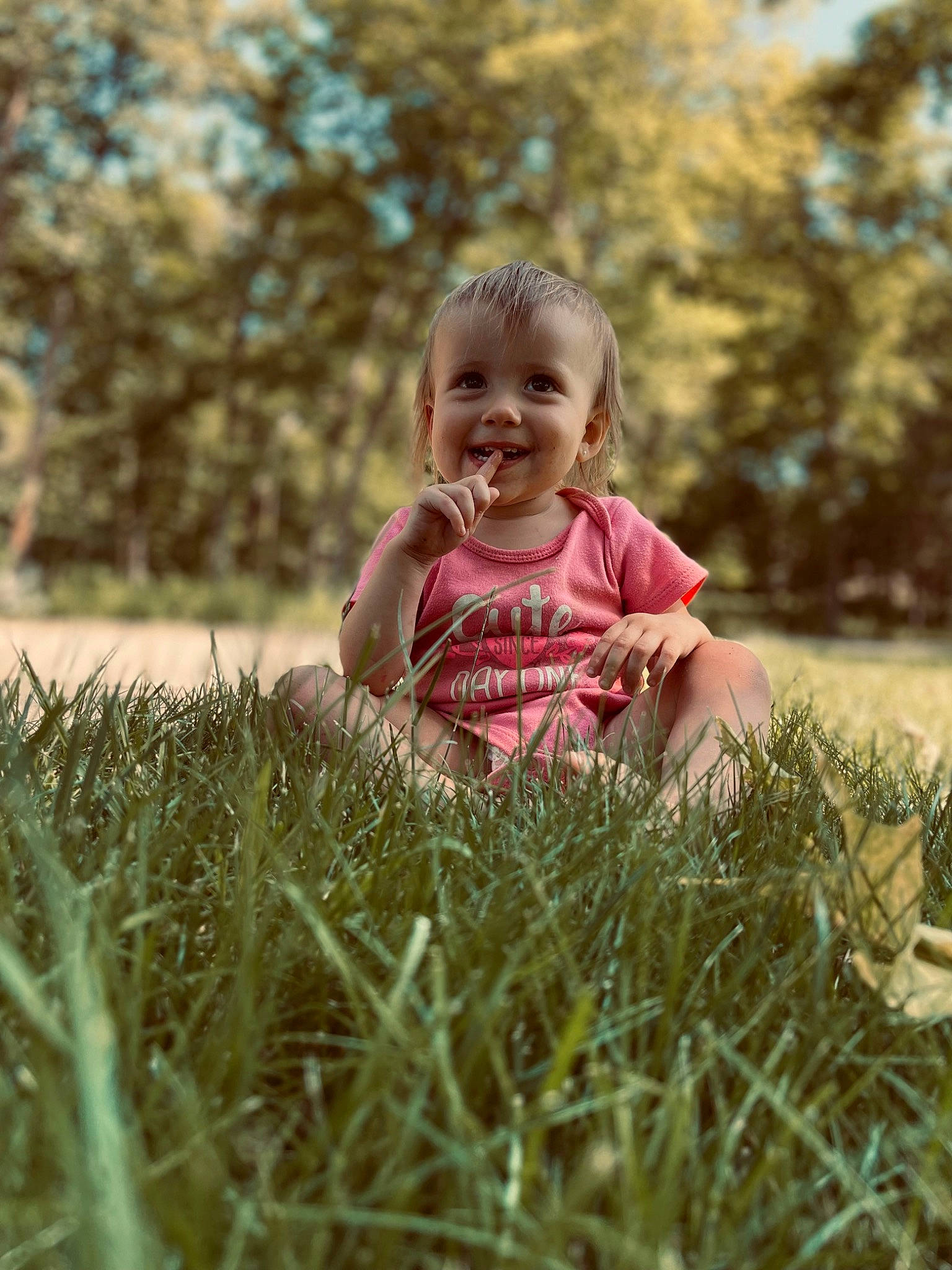 Brinley is registered to the contest to win money with this photo: baby, baby_toddler_clothing, eye, face, fun, grass, grass_family, grassland, hand, happy, joy, leisure, meadow, people_in_nature, person, plant, skin, smile, standing, toddler