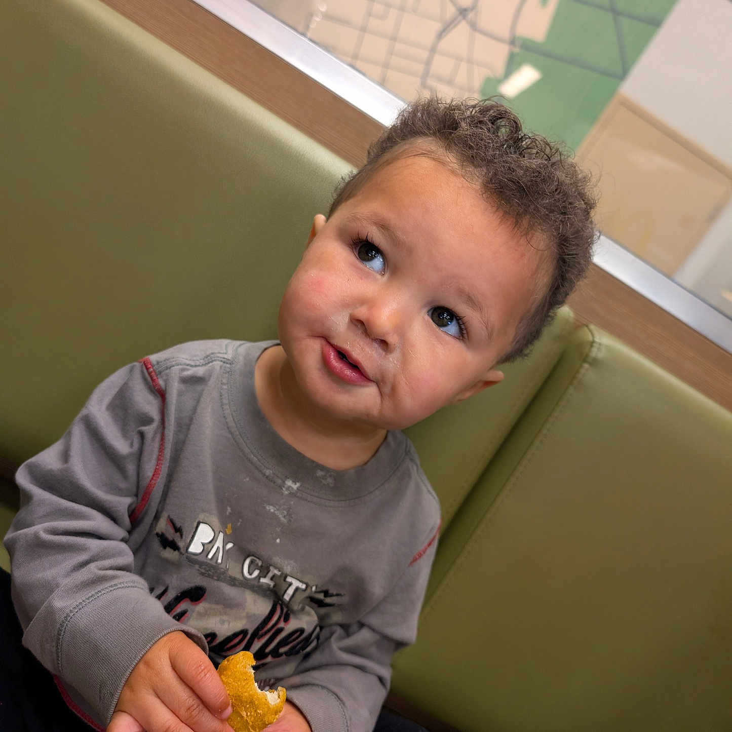 Andre is registered to the contest to win money with this photo: baby, bodypart, bread, clothing, couch, cream, dessert, face, finger, food, furniture, hand, head, icecream, knitwear, person, photography, portrait, sitting, t_shirt