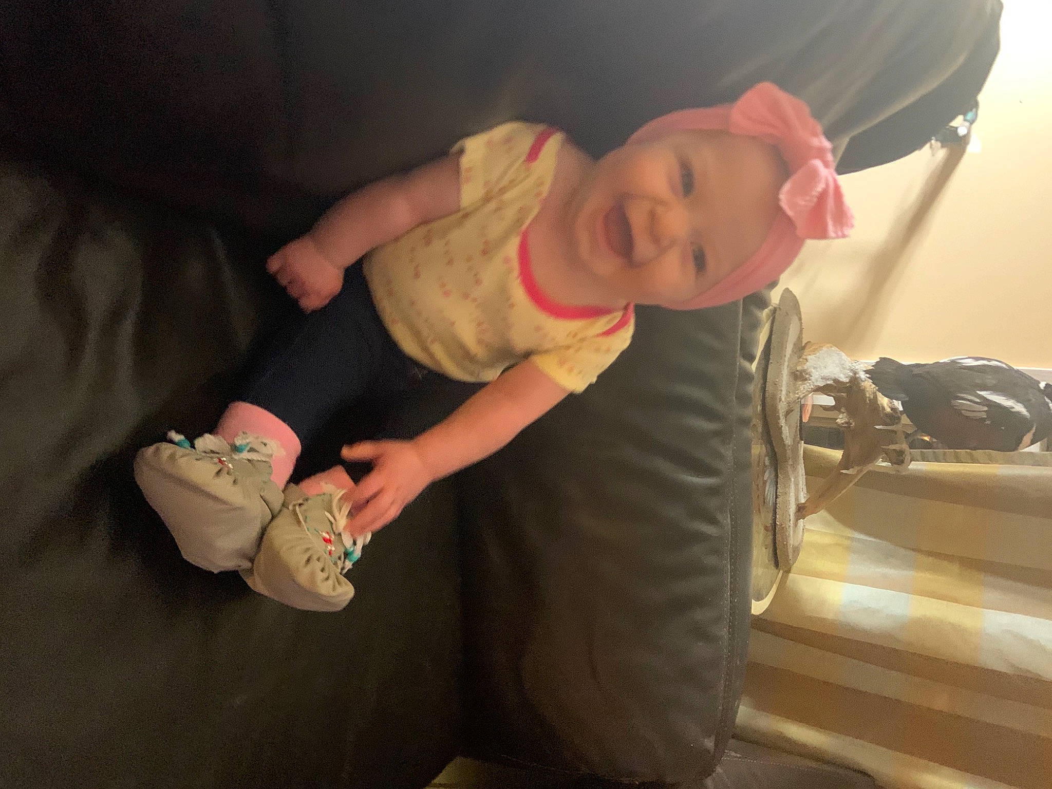 Leni is registered to the contest to win money with this photo: abdomen, baby, baby_products, baby_toddler_clothing, baseball_cap, cap, cheek, child, comfort, flooring, fun, hat, headwear, human_leg, mouth, person, sitting, skin, smile, thumb