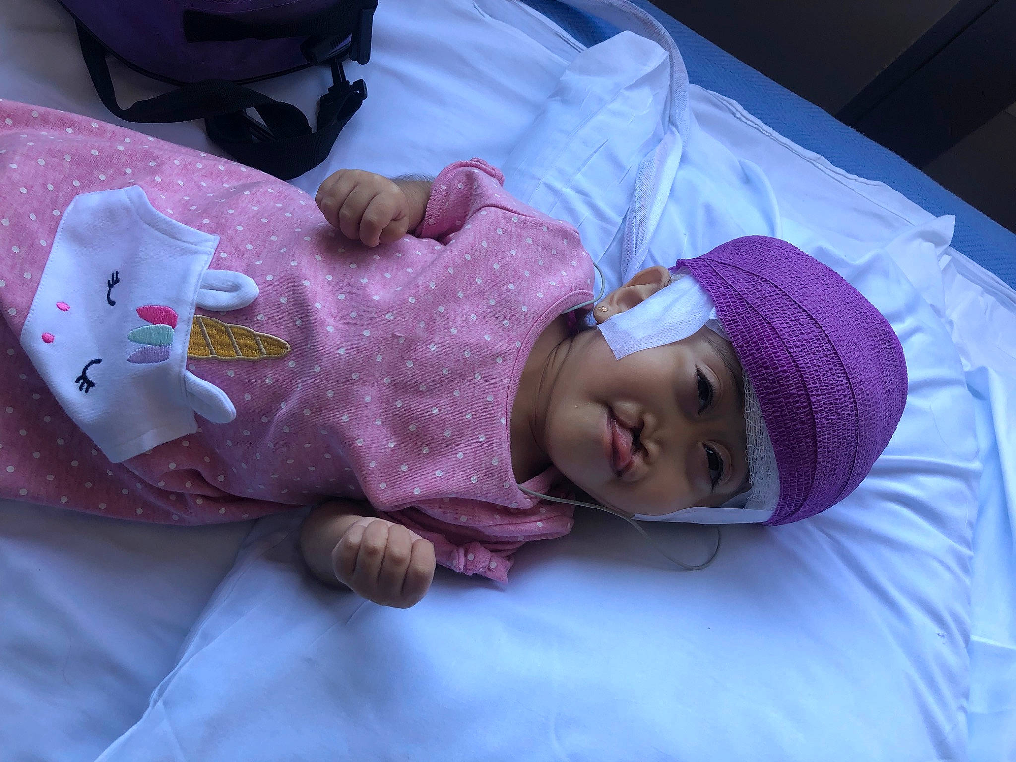 Aubree is registered to the contest to win money with this photo: baby, baby_products, baby_toddler_clothing, bedtime, child, comfort, finger, hand, hat, headgear, headwear, linens, magenta, nap, person, pink, purple, room, skin, sleep