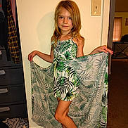 Kensley is registered to the contest to win money with this photo: child, girl, dress, leaf_pattern, fabric, barefoot, indoor, carpet, wall, light_switch, wardrobe, clothing, standing, pose, long_hair, smile, person, young, casual, home