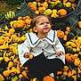 toddler, child, pumpkins, gourds, autumn, fall, outdoor, nature, cute, white_coat, curious, sitting, harvest, seasonal, colorful, vegetables, greenery, small_pumpkins, playful, festive