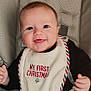 baby, infant, smiling, face, bib, christmas, car_seat, seatbelt, clothing, happy, child, cute, portrait, indoors, closeup, young, holiday, festive, person, seat