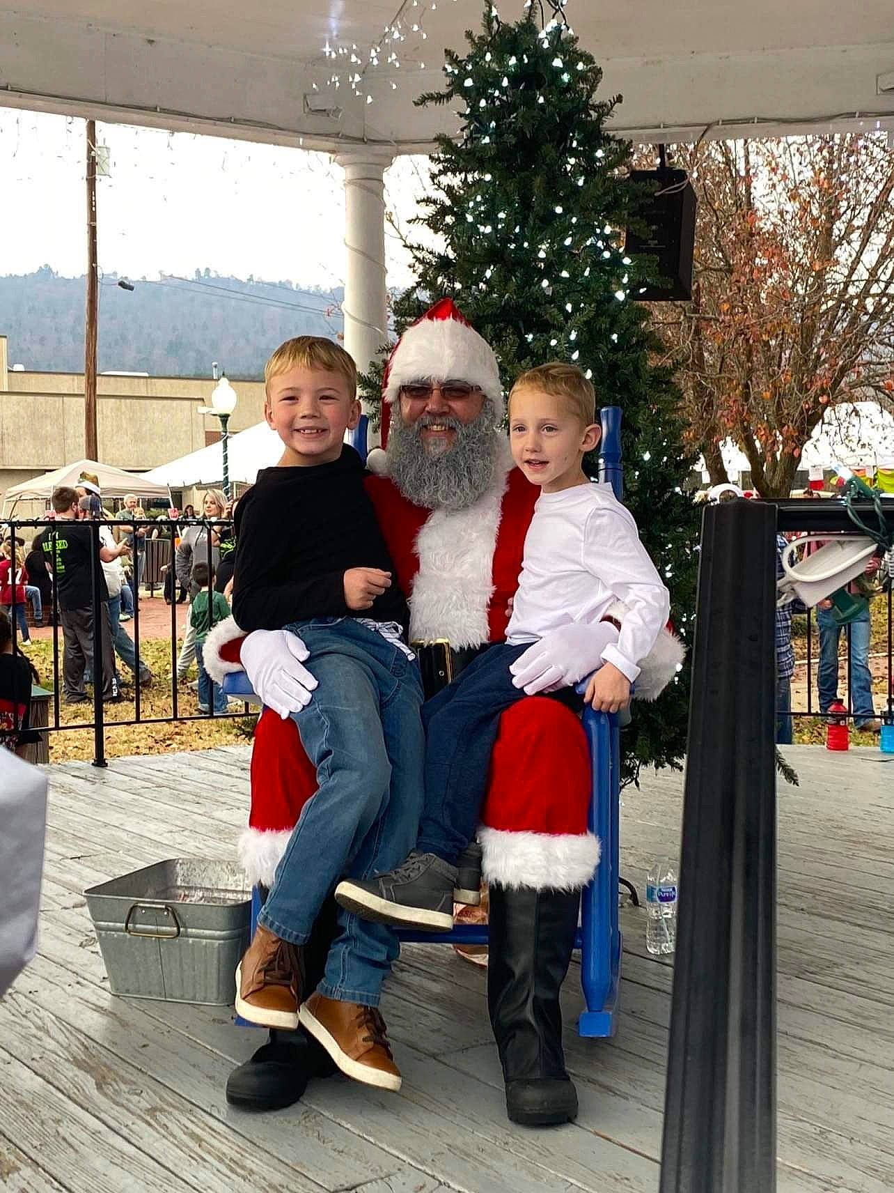 Megan is registered to the contest to win money with this photo: boot, chair, christmas, christmas_decoration, christmas_eve, christmas_ornament, christmas_tree, event, fun, happy, headwear, holiday, holiday_ornament, joy, lap, leisure, person, recreation, santa_claus, smile