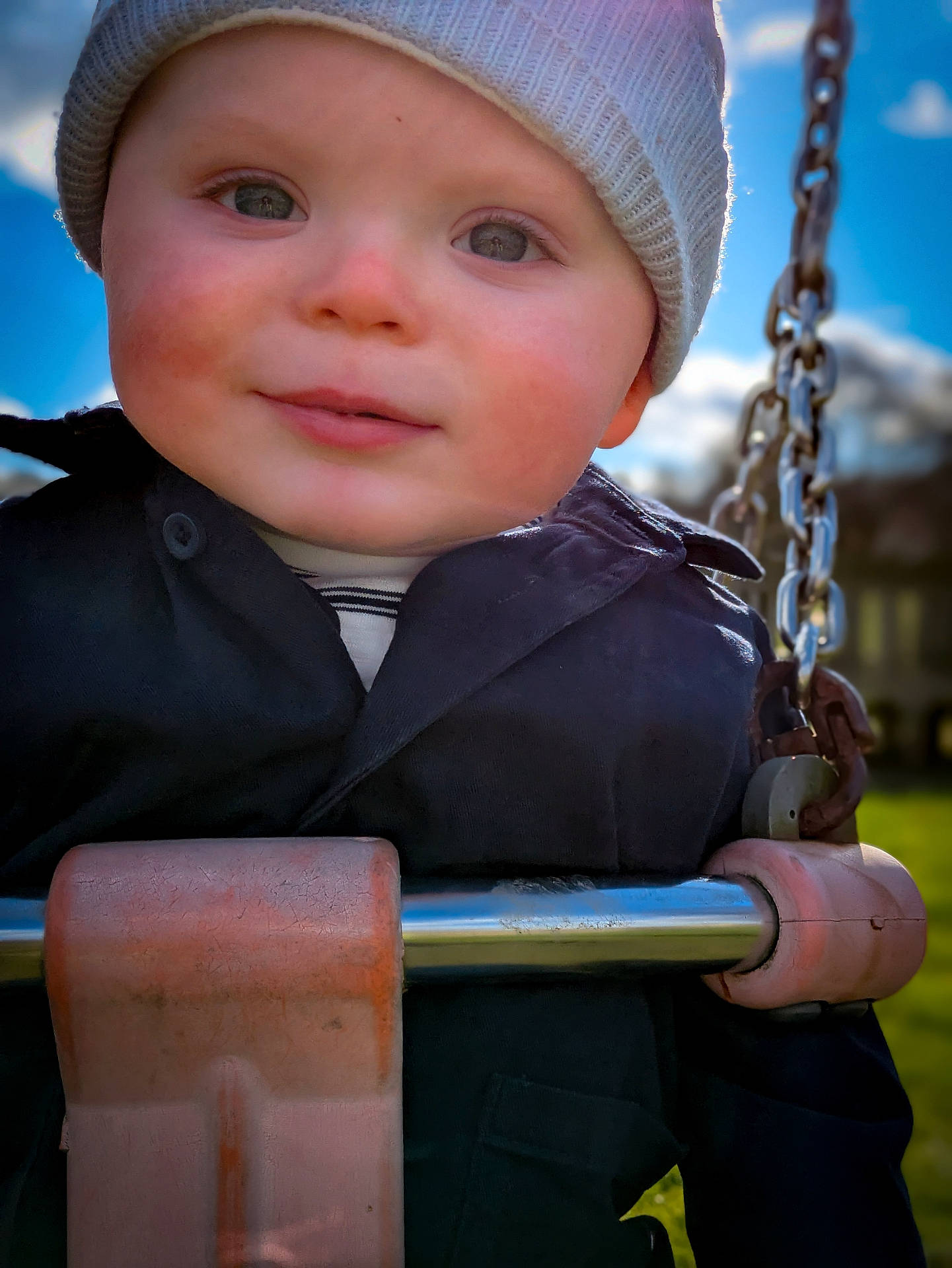 Grayson joined the competition — help win amazing prizes! baby, beanie, bodypart, bonnet, cap, clothing, coat, face, finger, hand, hat, head, mortarshell, outdoorplayarea, outdoors, person, playarea, swing, toy, weapon
