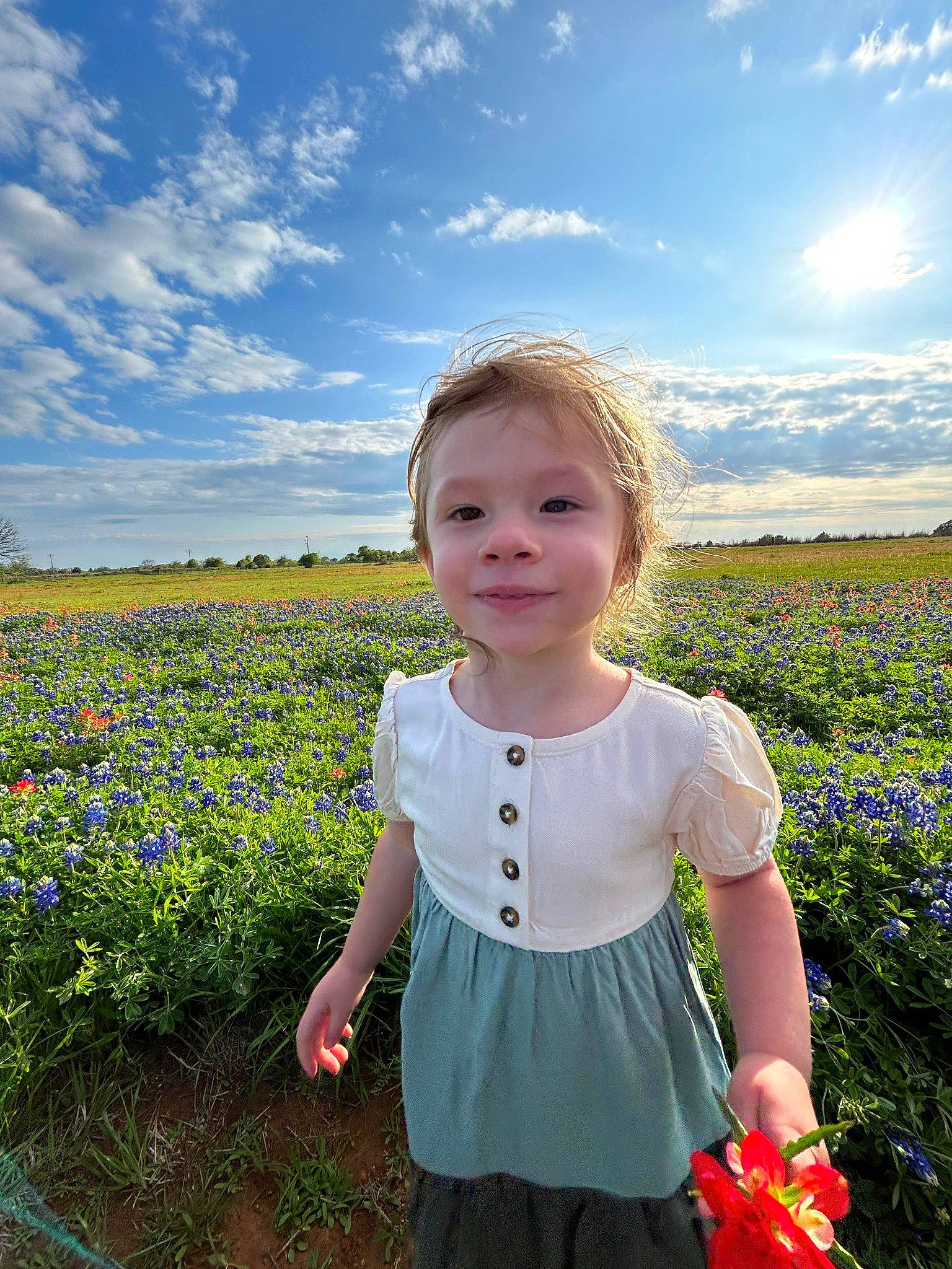 Zeniah joined the competition — help win amazing prizes! agriculture, baby_toddler_clothing, cloud, cumulus, electric_blue, flower, grass, grassland, happy, joy, meadow, natural_landscape, pattern, people_in_nature, person, plant, prairie, sky, sleeve, standing