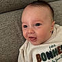 Louis a rejoint le concours — aidez-le/la à gagner de superbes lots ! baby, infant, face, eyes, smile, sweater, clothing, textile, couch, furniture, indoors, skin, head, person, happy, closeup, portrait, cute, expression, babywear