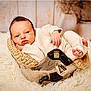 Louis participe au concours pour gagner de l'argent avec cette photo : baby, infant, helmet, knitwear, blanket, metal, face, newborn, portrait, cozy, soft_texture, indoor, rug, decor, vase, hand, foot, cute, resting, warm_colors