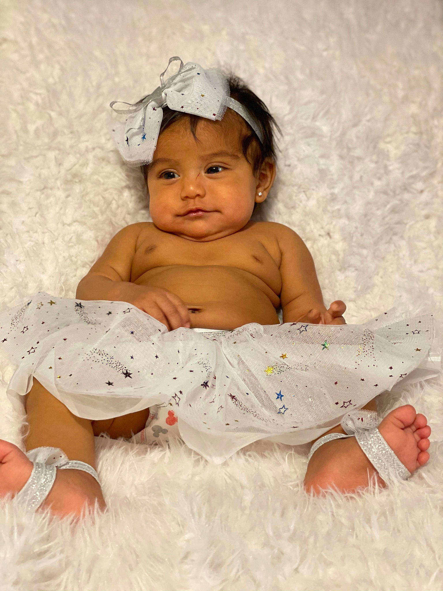 Jimena is registered to the contest to win money with this photo: abdomen, arm, baby, baby_bloomers, baby_products, baby_toddler_clothing, cheek, child, child_model, costume_accessory, embellishment, hair_accessory, hand, headband, headpiece, linens, person, skin, stomach, toddler