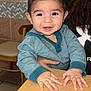 adult_hand, baby, blue_hoodie, casual, chair, child, cute, eyes, face, hair, hands, happy, indoor, kitchen, person, portrait, smiling, table, tile_wall, toddler