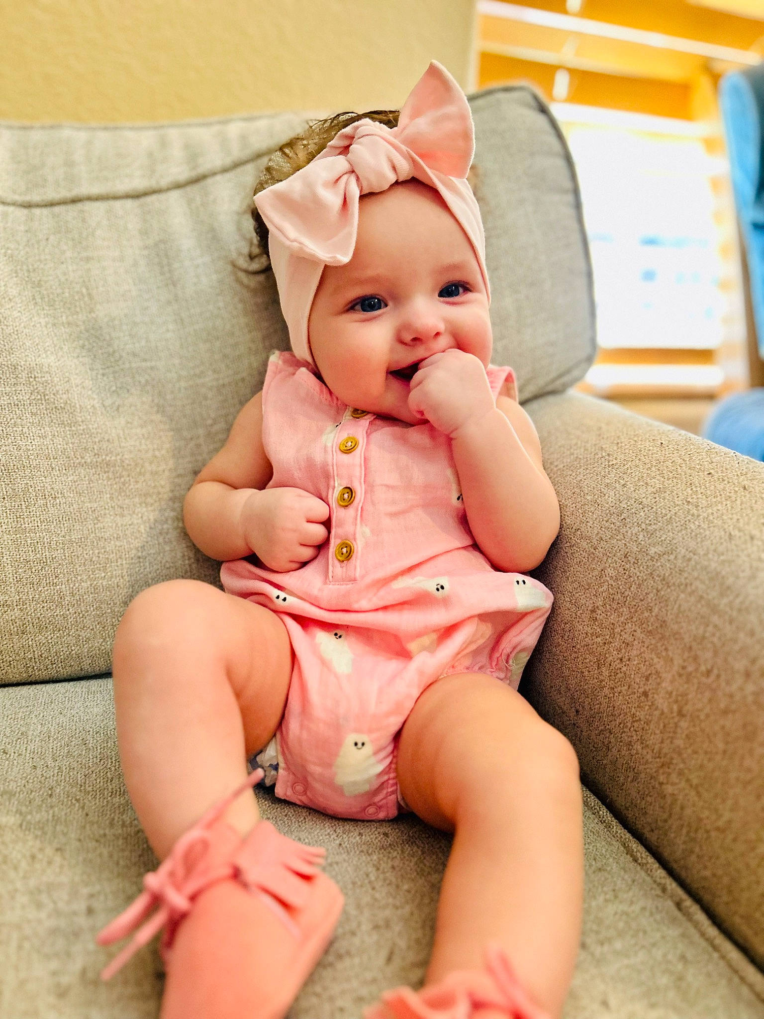 Lydia is registered to the contest to win money with this photo: abdomen, baby_toddler_clothing, comfort, computer_keyboard, dress, fashion_accessory, foot, happy, hat, head, headwear, human_body, human_leg, knee, lap, person, pink, sitting, smile, stuffed_toy