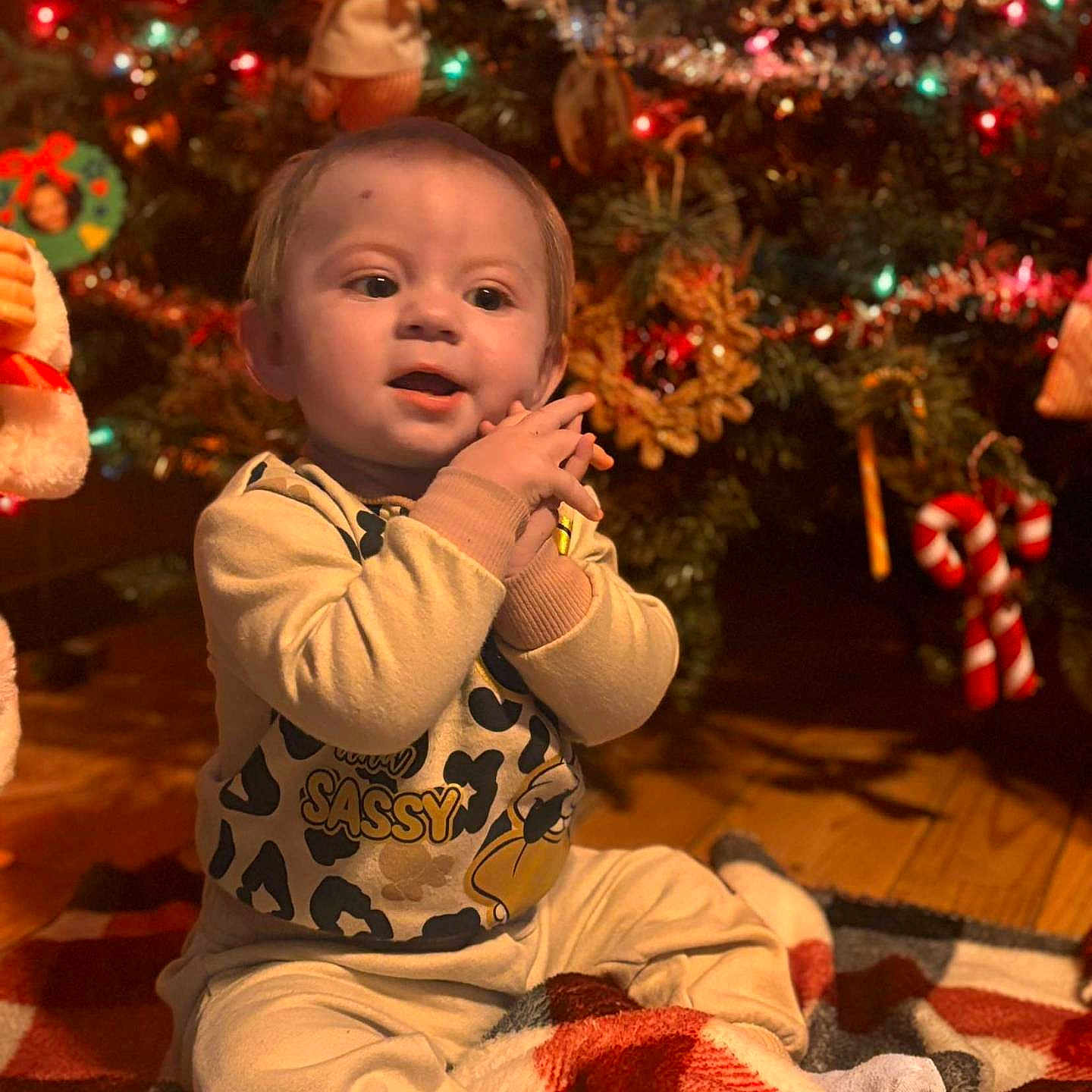 Issabella joined the competition — help win amazing prizes! accessories, baby, blanket, bodypart, child, christmas, christmasdecorations, christmastree, face, female, festival, finger, girl, head, lighting, openingpresent, person, photography, portrait, sitting