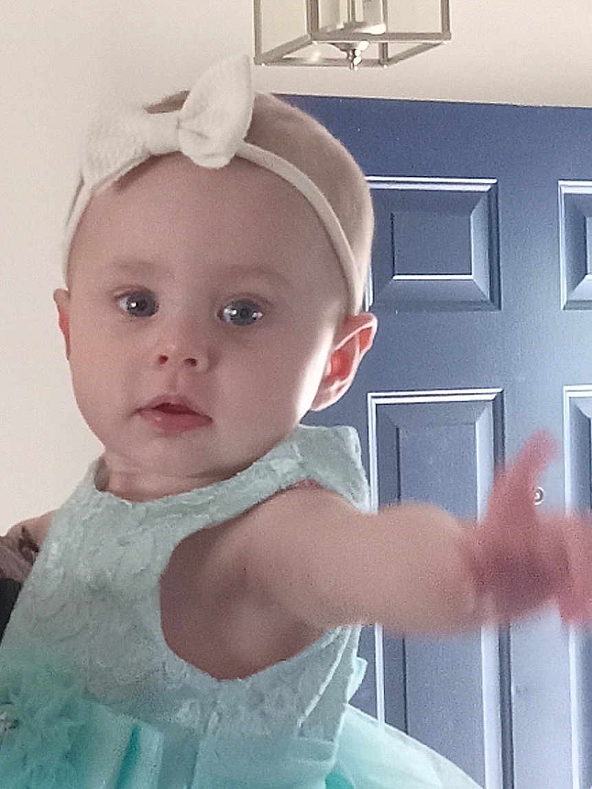 Layla joined the competition — help win amazing prizes! baby, child, headband, dress, mint_color, reaching, indoor, door, light_fixture, curious, person, cute, young_child, portrait, closeup, infant, toddler, baby_girl, fashion, accessory