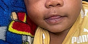 Antron joined the competition — help win amazing prizes! baby, infant, face, eyes, clothing, yellow, puma, blanket, colorful, pacifier, close_up, cute, child, young, portrait, skin, expression, laying, soft, comfort