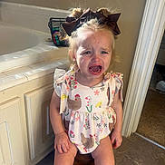 Finlee Blayke is registered to the contest to win money with this photo: bathroom, bow, cabinet, chicken_pattern, child, crying, doorway, dress, emotion, expression, hair_accessory, indoor, light, person, pink_shoes, shadow, stool, tears, tile_floor, toddler