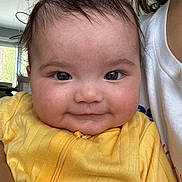 Anaiah is registered to the contest to win money with this photo: baby, child, infant, face, smile, yellow_clothing, person, portrait, indoors, cute, young_child, human, skin, hair, happy, closeup, eyelashes, cheeks, zipper, toddler