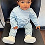 Mateo is registered to the contest to win money with this photo: toddler, child, baby, sitting, chair, black_chair, light_blue_clothing, sneakers, indoors, wooden_floor, curly_hair, big_eyes, cute, portrait, casual_wear, looking_at_camera, young_child, innocence, cozy, comfortable