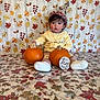 Mateo joined the competition — help win amazing prizes! baby, child, pumpkin, party_hat, autumn, fall_leaves, background, blanket, sitting, cute, celebration, ten_months, clothing, white_shoes, patterned_pants, indoor, portrait, face, young, festive