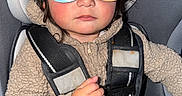 Mateo joined the competition — help win amazing prizes! accessory, babytrend, beige, car_seat, child, clothing, cute, expression, fleece, glasses, headgear, indoor, person, portrait, safety, seatbelt, serious, sitting, toddler, young_child