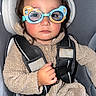 Mateo joined the competition — help win amazing prizes! toddler, child, car_seat, seatbelt, glasses, fleece, beige, serious, expression, babytrend, clothing, person, sitting, indoor, safety, cute, young_child, portrait, headgear, accessory