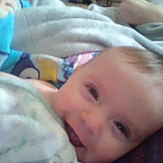 Daxtin joined the competition — help win amazing prizes! baby, smiling, close_up, blanket, teether, indoor, person, infant, face, happy, child, soft, toy, comfort, lying_down, home, furniture, basketball, colorful, cute