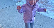 Gianna joined the competition — help win amazing prizes! toddler, child, purple_jacket, hood, smile, snow, sidewalk, winter, outdoor, cars, urban, cold_weather, footwear, pants, standing, happy, person, daylight, concrete, playful