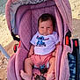 Laura participe au concours pour gagner de l'argent avec cette photo : baby, child, car_seat, pink, tshirt, beach, sand, shells, keys, footwear, infant, outdoor, person, cute, expression, clothing, seat, toy, pacifier, sunlight