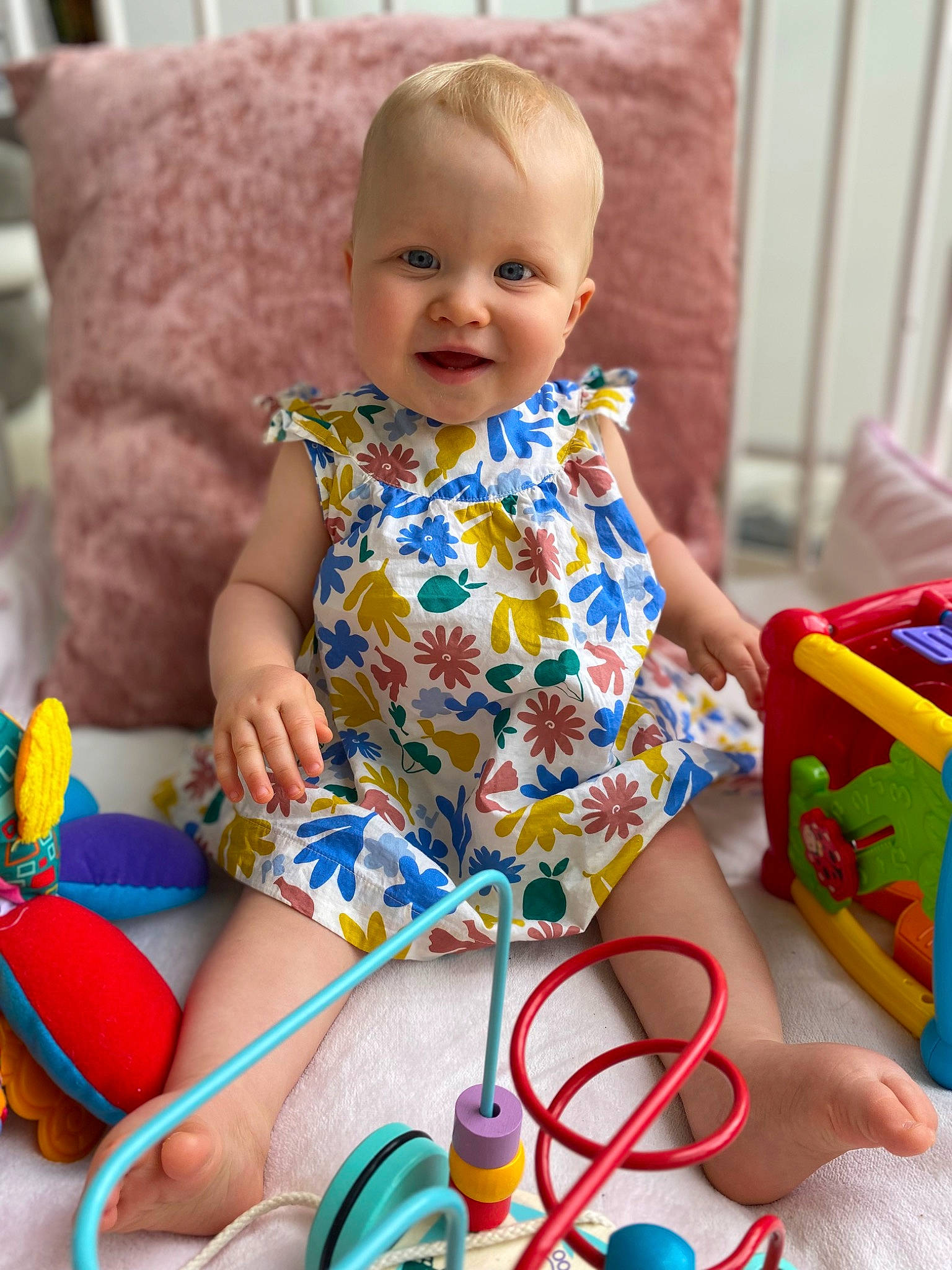 Olivia a rejoint le concours — aidez-le/la à gagner de superbes lots ! baby, baby_playing_with_toys, baby_toddler_clothing, cheek, child, dress, fun, happy, pattern, person, photograph, product, purple, red, sitting, skin, smile, snapshot, toddler, toy