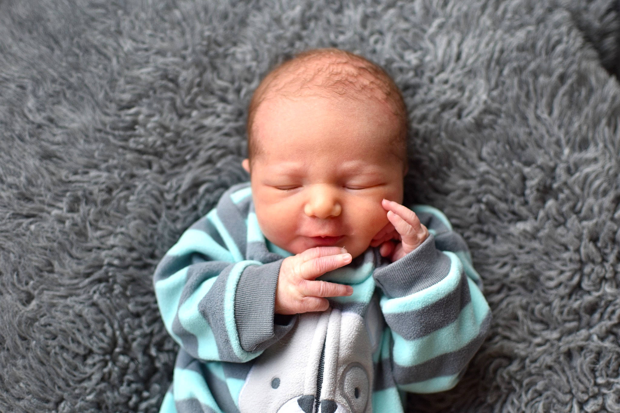 Bruce is registered to the contest to win money with this photo: baby, baby_toddler_clothing, cheek, child, facial_expression, finger, fun, gesture, grass, hand, happy, lip, mouth, nose, people_in_nature, person, skin, smile, textile, toddler