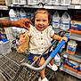 Alani joined the competition — help win amazing prizes! toddler, child, shopping_cart, smiling, white_shoes, white_blouse, hand, toy_purse, store_shelves, plastic_bottles, indoor, floor, person, cute, casual_clothing, shopping, baby, happy, hair_tie, portrait
