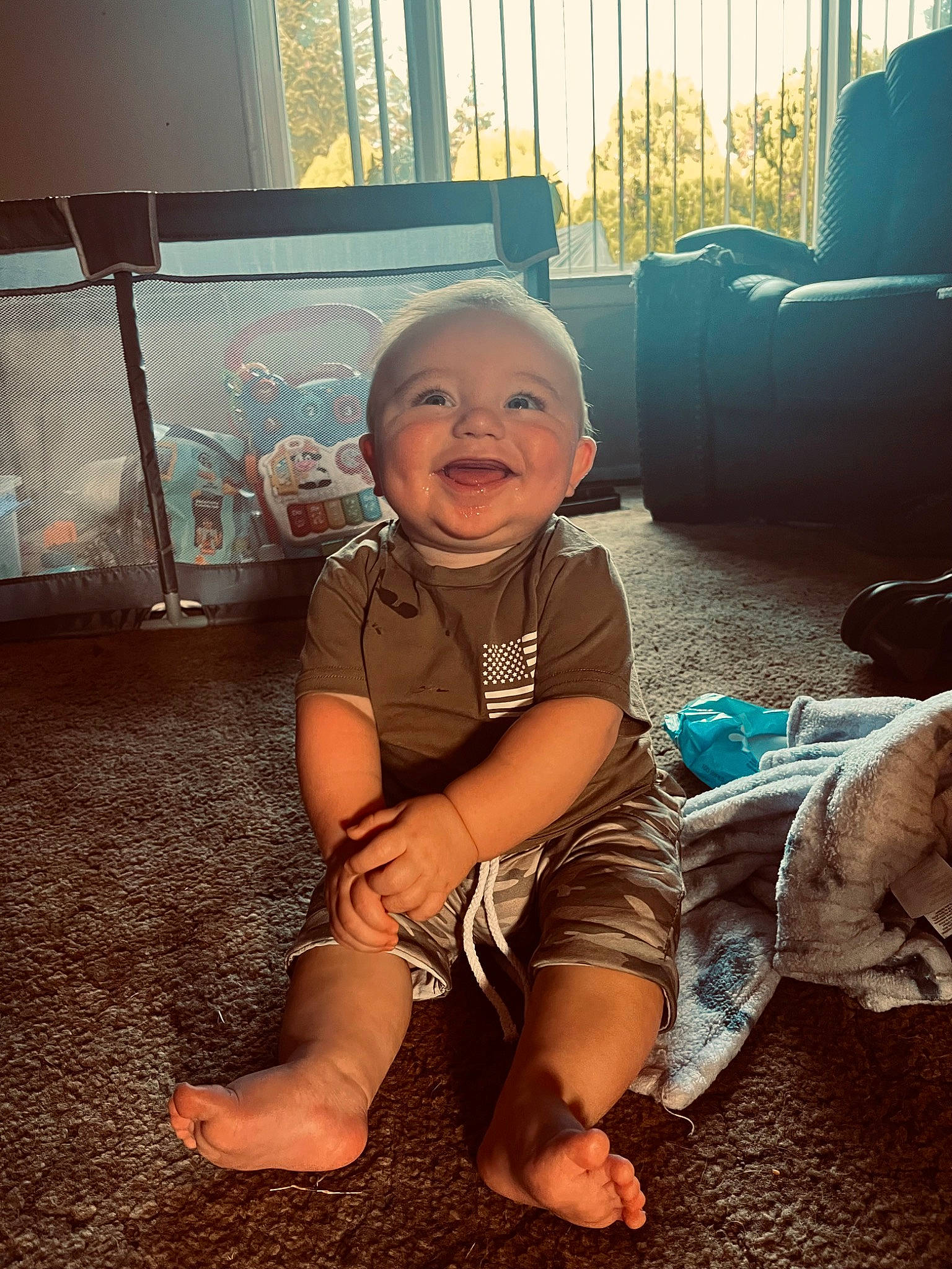 Indigo joined the competition — help win amazing prizes! baby, baby_toddler_clothing, barefoot, cool, facial_expression, flash_photography, floor, flooring, foot, fun, grass, happy, leg, mouth, person, sitting, skin, smile, tints_and_shades, toddler