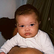 Rome joined the competition — help win amazing prizes! baby, infant, person, face, portrait, white_clothing, curtains, indoor, skin, human, child, looking_at_camera, holding_on, back, dark_hair, closeup, expression, young, cute, serious