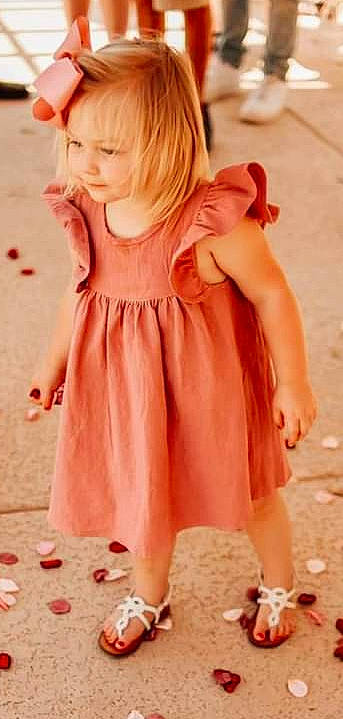 Annie is registered to the contest to win money with this photo: baby_toddler_clothing, day_dress, dress, gesture, hair, happy, head, joint, long_hair, neck, one_piece_garment, orange, person, pink, shoulder, skin, sleeve, smile, summer, toddler
