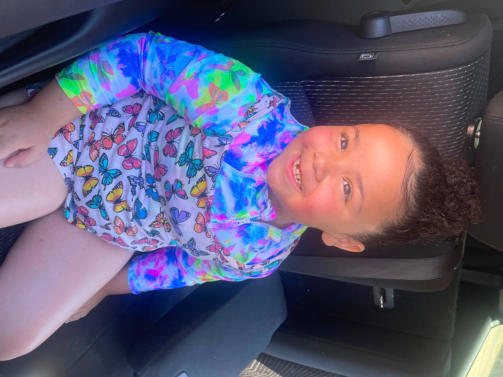 Jaylah joined the competition — help win amazing prizes! auto_part, automotive_design, automotive_exterior, black_hair, car_seat, child, cool, electric_blue, fun, hat, headgear, human_leg, joy, leisure, muscle, pattern, person, smile, t_shirt, thigh