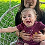 Madalynn joined the competition — help win amazing prizes! baby, child, smiling, outdoor, grass, swing_chair, pigtails, holding, happy, person, young_child, nature, sunlight, casual_clothing, portrait, playful, seated, family, fun, summer