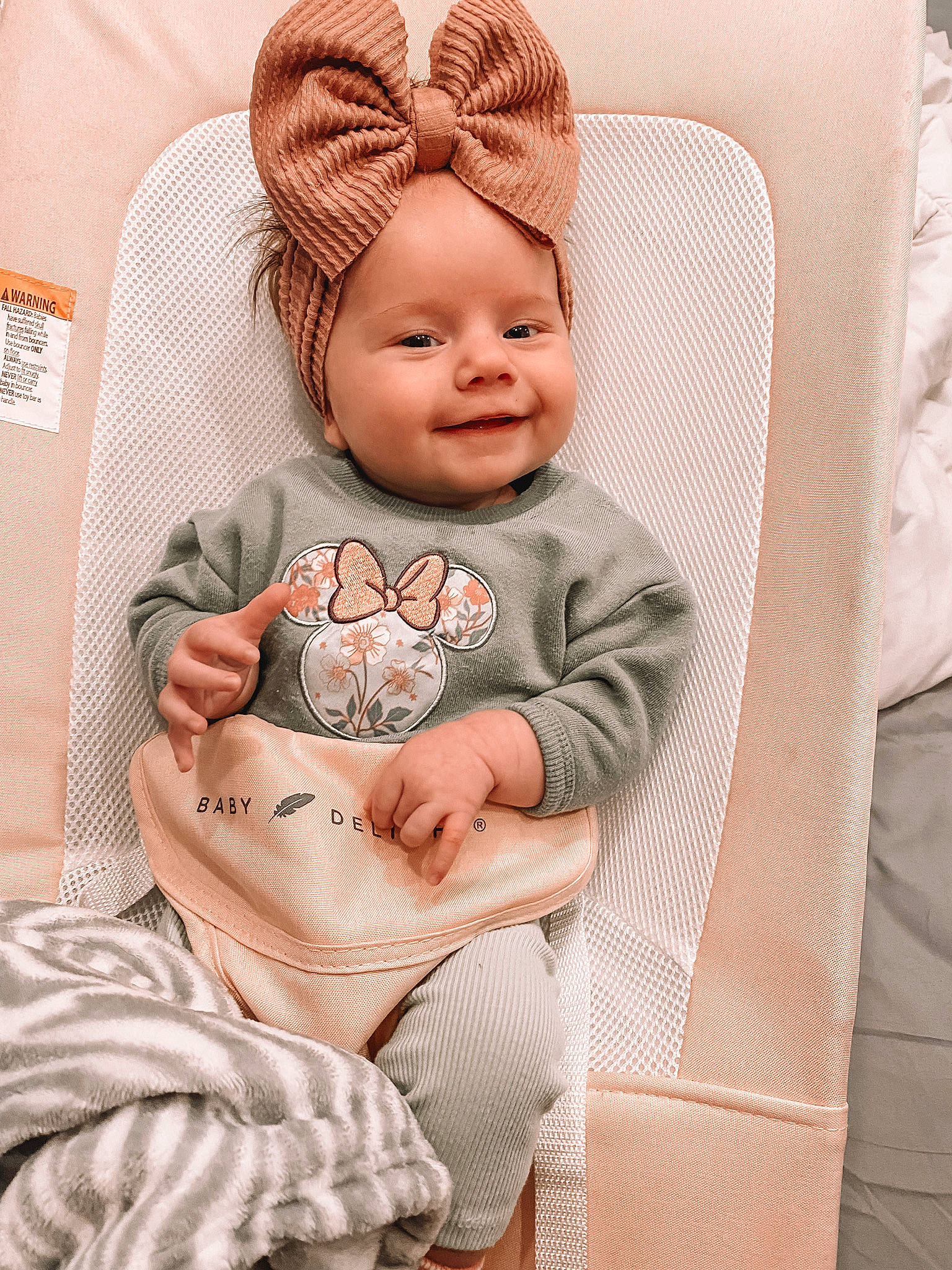 Oaklee joined the competition — help win amazing prizes! baby, baby_toddler_clothing, cap, chair, child, comfort, costume_hat, happy, hat, headwear, human_body, joy, linens, pattern, person, pink, sitting, skin, sleeve, smile