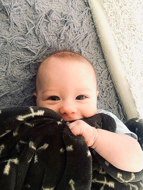 Harlen is registered to the contest to win money with this photo: arm, baby, baby_toddler_clothing, comfort, eyelash, finger, flash_photography, gesture, grey, hand, happy, lip, nail, pattern, person, skin, thumb, toddler, tree, wood