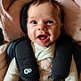 baby, infant, smiling, face, blue_eyes, car_seat, straps, clothing, bunny_design, pink, beige, soft, plush, cute, happy, child, portrait, indoors, closeup, young