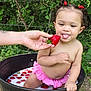Olivianna joined the competition — help win amazing prizes! toddler, child, strawberry, milk, outdoor, nature, greenery, hair_ties, pink_skirt, barrel, playful, tongue_out, hand, summer, cute, fruit, skin, baby, fun, garden