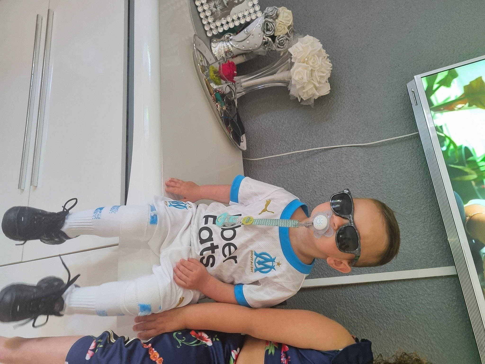 Swany participe au concours pour gagner de l'argent avec cette photo : child, elbow, eyewear, fun, goggles, hat, human_leg, knee, leisure, person, room, shorts, sitting, sportswear, sunglasses, t_shirt, thigh, tree, visual_arts, white
