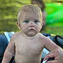 adult_hand, background_blur, bare_chest, blue_eyes, child, closeup, green_float, hand, outdoor, person, pool, serious_expression, short_hair, skin, summer, swim_trunks, swimming, toddler, water, wet_skin