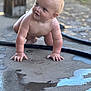 Ryker is registered to the contest to win money with this photo: baby, child, crawling, wet_floor, water, reflection, concrete, outdoor, curious, skin, hands, face, expression, blond_hair, young_child, person, infant, natural_light, playful, floor