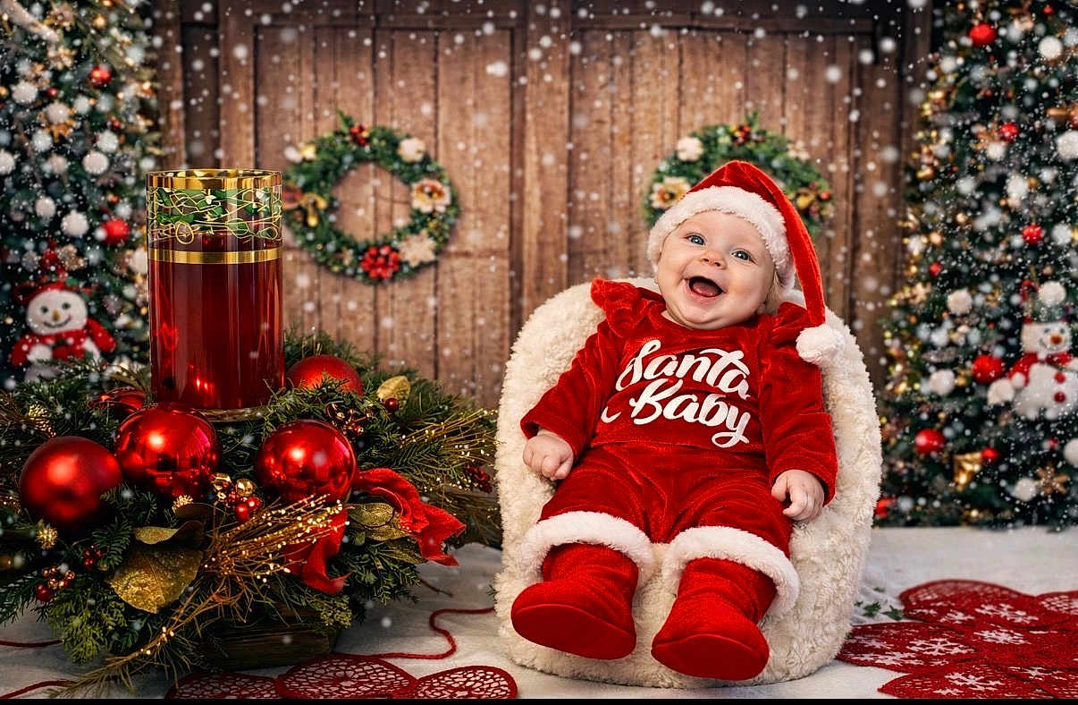 Leauna joined the competition — help win amazing prizes! baby, child, christmas, holiday, festive, red_outfit, santa_baby, smiling, chair, wreath, ornaments, christmas_tree, snow_effect, decorations, happy, indoor, portrait, cute, seasonal, celebration