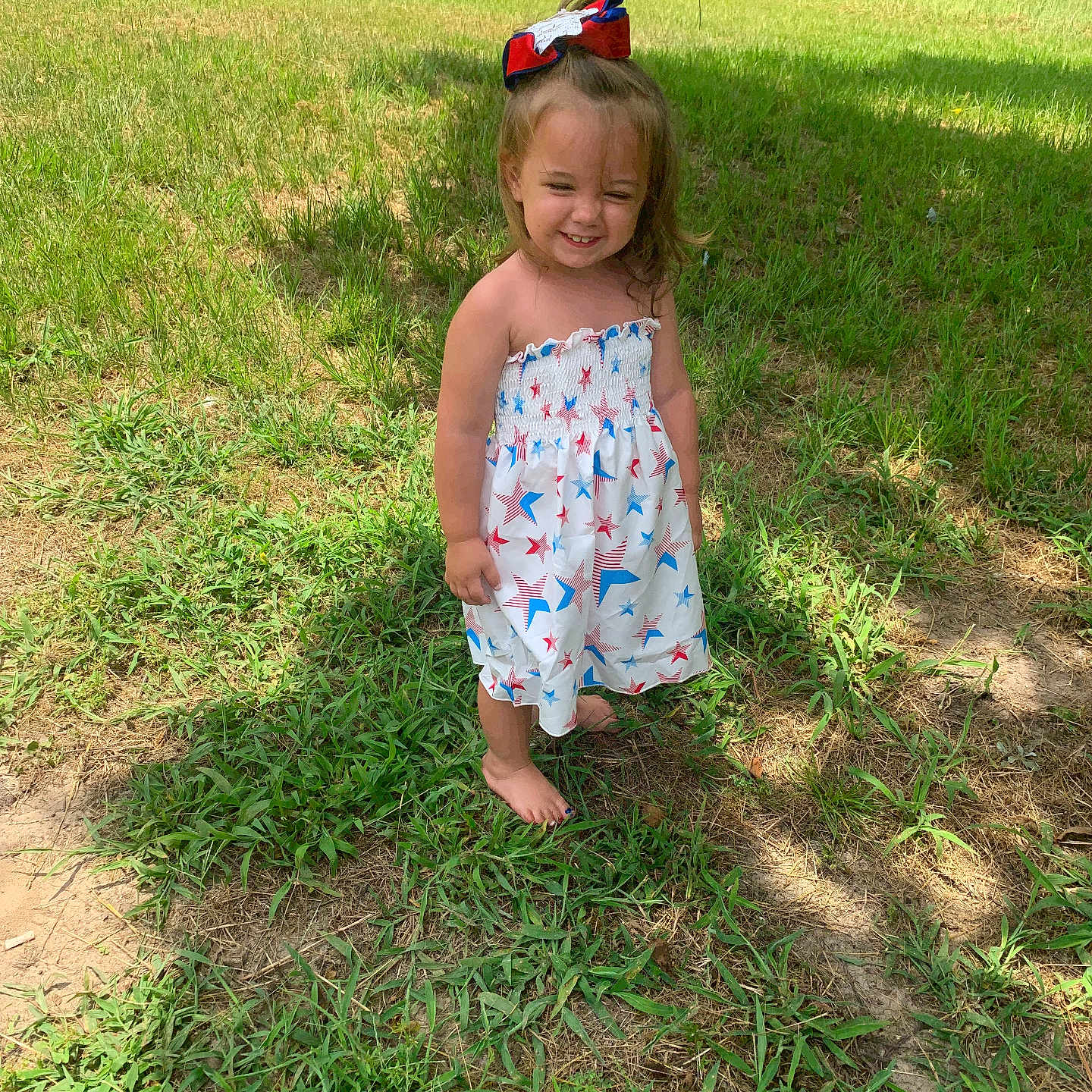 Symphonee Lyric is registered to the contest to win money with this photo: barefoot, bow, casual_clothing, child, daytime, dress, girl, grass, greenery, happy, headwear, nature, outdoor, person, playful, smile, standing, summer, sunlight, young