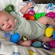 Sawyer joined the competition — help win amazing prizes! baby, infant, smiling, easter_eggs, colorful, blanket, cute, soft, playful, toy, indoors, child, happy, blue_eyes, clothing, crawling, celebration, festive, lying_down, holding