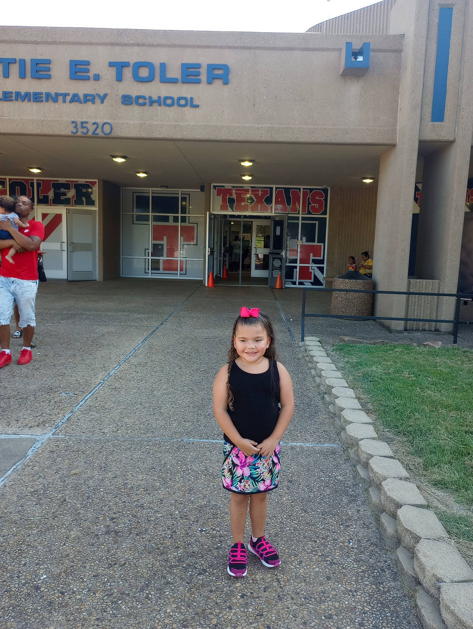 Dallas joined the competition — help win amazing prizes! asphalt, building, child, city, event, facade, footwear, fun, hat, joy, leisure, magenta, pattern, pedestrian, person, recreation, sandal, sidewalk, smile, toddler